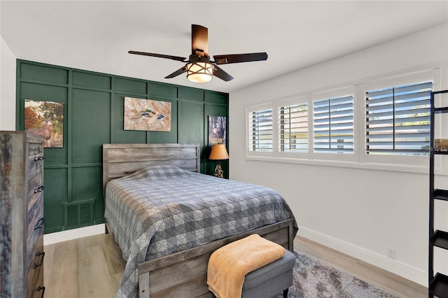 bedroom with light hardwood / wood-style flooring and ceiling fan