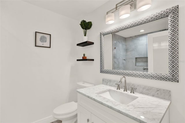 bathroom with vanity, an enclosed shower, and toilet