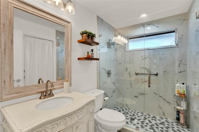 bathroom featuring vanity, an enclosed shower, and toilet