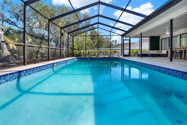 view of swimming pool featuring a patio area, an outdoor hangout area, ceiling fan, and glass enclosure