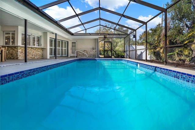 view of swimming pool with a lanai and a patio