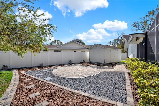 view of yard with a shed, a lanai, and a patio