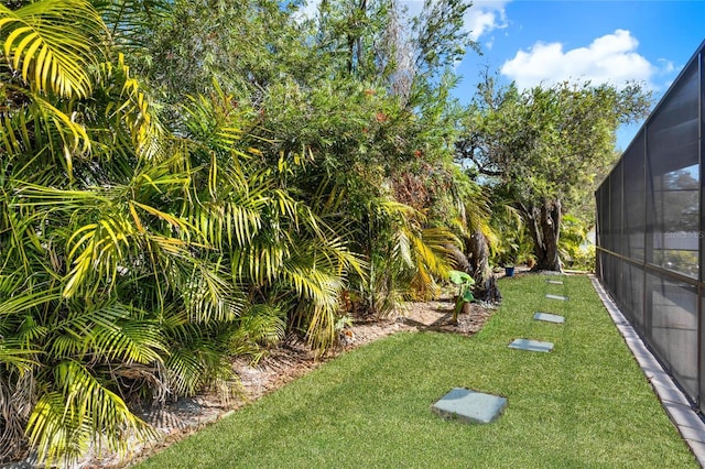 view of yard featuring glass enclosure