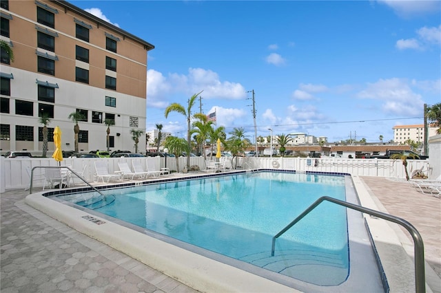 pool featuring a patio area and fence