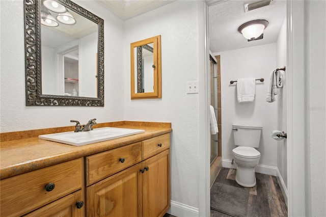 full bathroom with visible vents, baseboards, toilet, a shower stall, and vanity