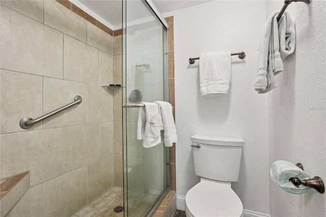 bathroom featuring a shower stall and toilet