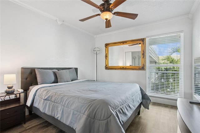 bedroom featuring ornamental molding, ceiling fan, and wood finished floors