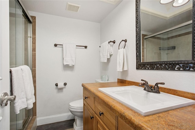 full bath featuring visible vents, baseboards, toilet, a shower stall, and vanity