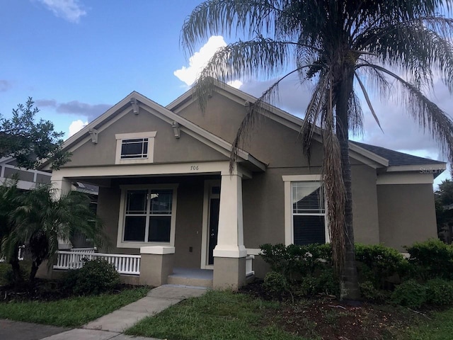 view of front of property with a porch and stucco siding