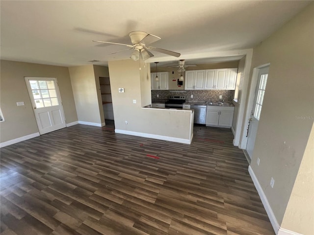 kitchen with white cabinetry, backsplash, dark wood-type flooring, and stainless steel appliances