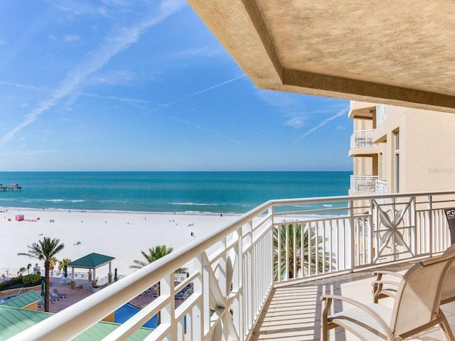 balcony with a water view and a beach view