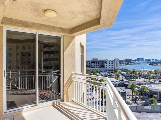 balcony featuring a view of city and a water view