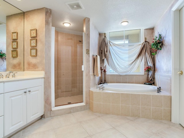 full bathroom with visible vents, a stall shower, a textured ceiling, vanity, and tile patterned flooring