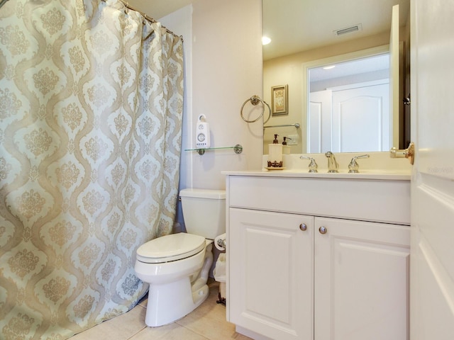 full bathroom featuring toilet, vanity, visible vents, and tile patterned floors