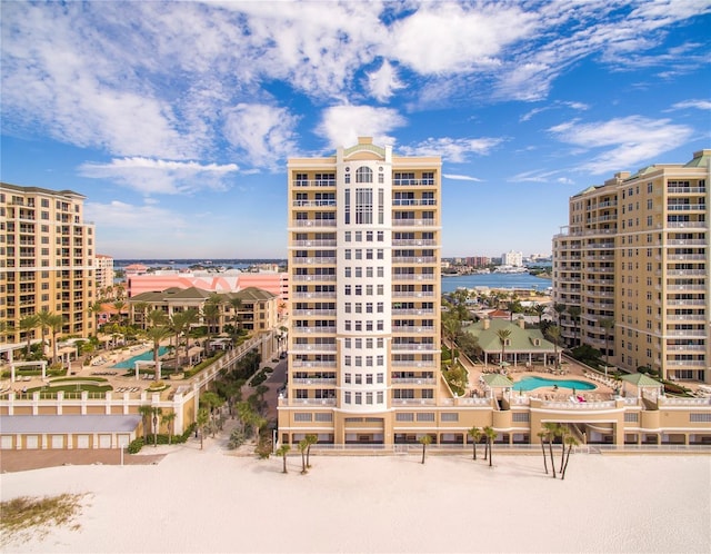 view of building exterior featuring a water view and a city view