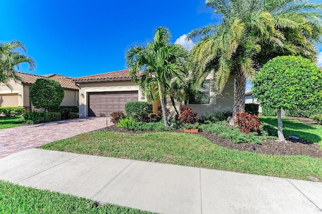 view of front of home with a garage and a front lawn