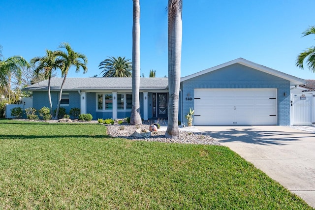 ranch-style house with a garage and a front lawn