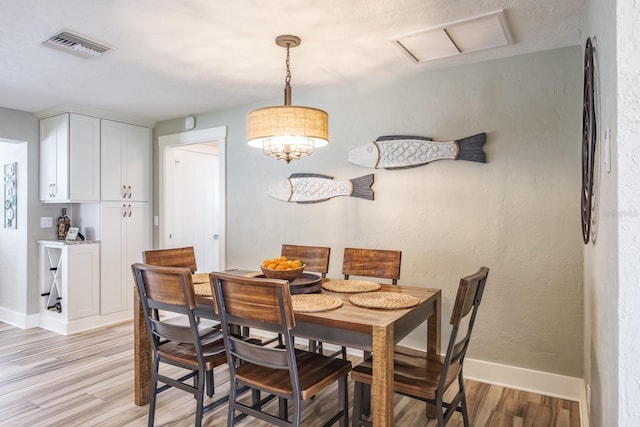 dining area featuring light wood-type flooring