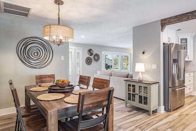 dining room featuring a chandelier and light hardwood / wood-style floors