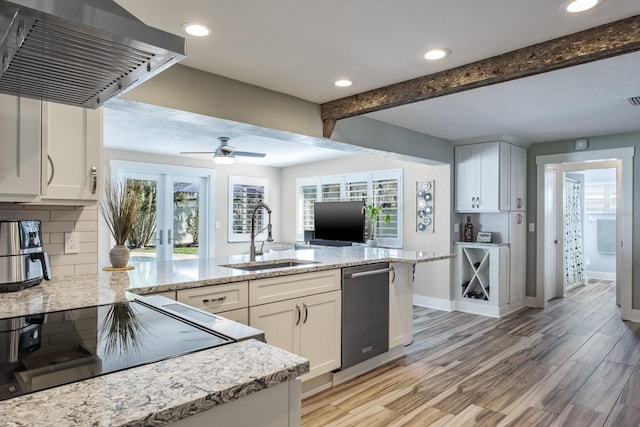 kitchen with sink, a wealth of natural light, ventilation hood, and white cabinets