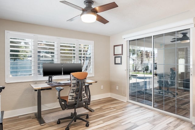 home office featuring hardwood / wood-style floors and ceiling fan