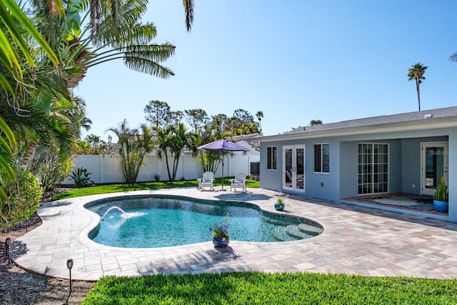 view of swimming pool featuring french doors, pool water feature, and a patio area