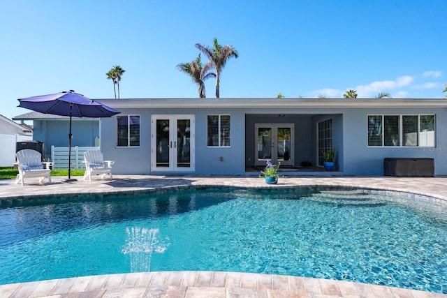 view of pool featuring a patio area and french doors