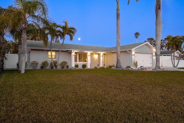 single story home with a yard and a garage