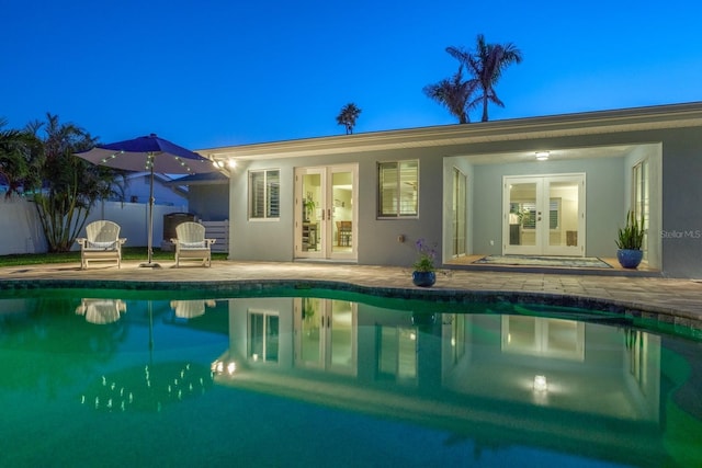 view of pool with a patio and french doors