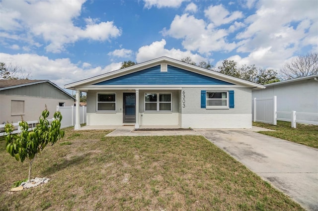6303 Central Ave, New Port Richey, FL 34653 - view of front facade with covered porch and a front lawn