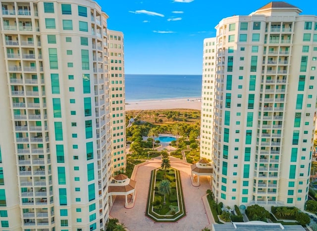 view of building exterior with a water view and a view of the beach