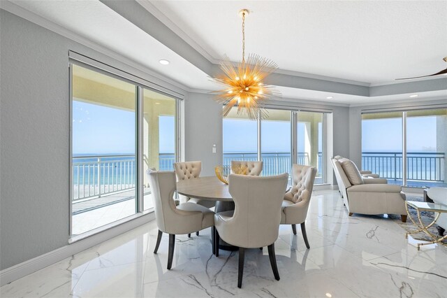 dining space with marble finish floor, ornamental molding, a wealth of natural light, and a notable chandelier