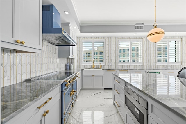 kitchen featuring wall chimney exhaust hood, stainless steel microwave, marble finish floor, double oven range, and a sink