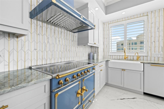 kitchen with tasteful backsplash, range with two ovens, paneled dishwasher, wall chimney range hood, and a sink