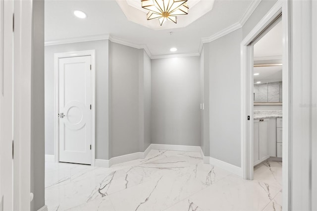 corridor with marble finish floor, baseboards, and ornamental molding