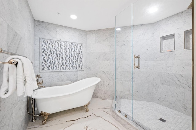 bathroom with recessed lighting, a soaking tub, tiled shower, and marble finish floor