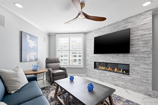 living room with marble finish floor, crown molding, a ceiling fan, a textured ceiling, and a stone fireplace