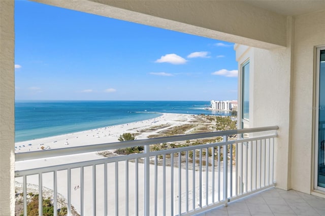 balcony with a water view and a beach view