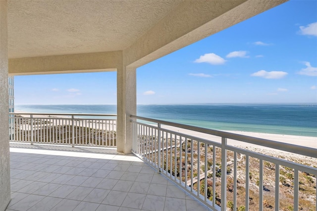 balcony with a view of the beach and a water view