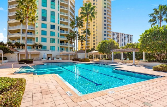 community pool featuring a pergola and a patio