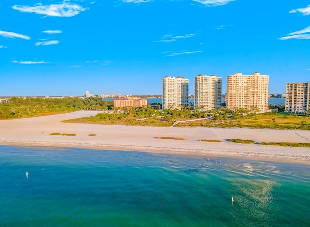 birds eye view of property with a water view, a view of city, and a view of the beach