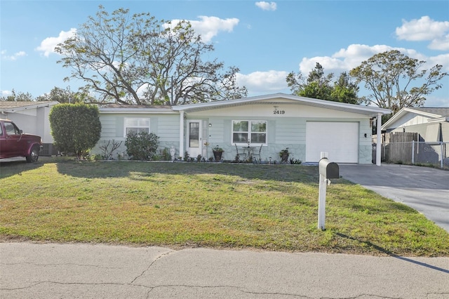 2419 Palmwood Dr, Holiday, FL 34690 - ranch-style home featuring a garage and a front lawn