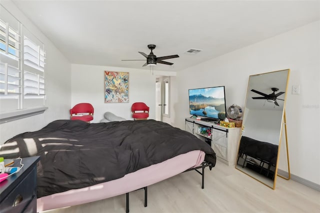 2419 Palmwood Dr, Holiday, FL 34690 - bedroom with ceiling fan and light wood-type flooring