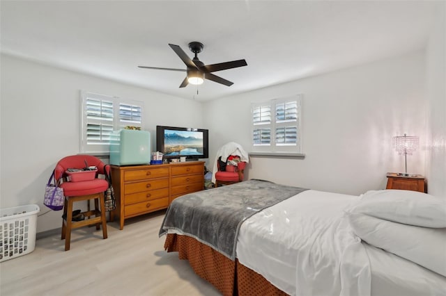 2419 Palmwood Dr, Holiday, FL 34690 - bedroom featuring multiple windows, light hardwood / wood-style flooring, and ceiling fan