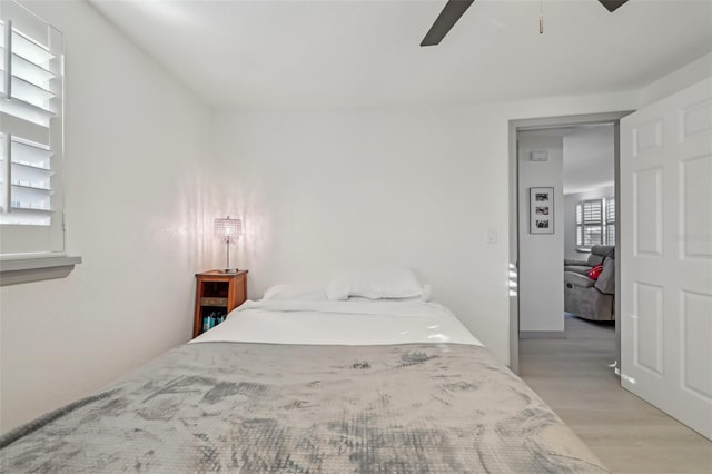 2419 Palmwood Dr, Holiday, FL 34690 - bedroom with ceiling fan and light wood-type flooring