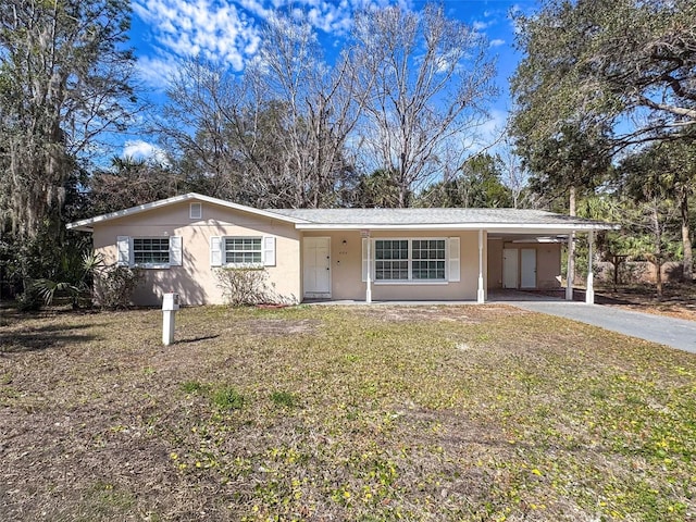 ranch-style house with a carport and a front yard