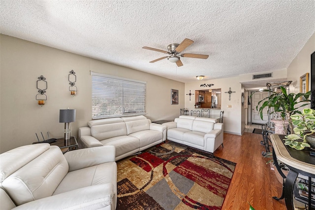 6308 Newtown Cir Unit 8C5, Tampa, FL 33615 - living room featuring visible vents, a textured ceiling, ceiling fan, and wood finished floors