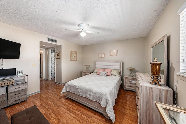 6308 Newtown Cir Unit 8C5, Tampa, FL 33615 - bedroom with visible vents, a textured ceiling, wood finished floors, baseboards, and ceiling fan