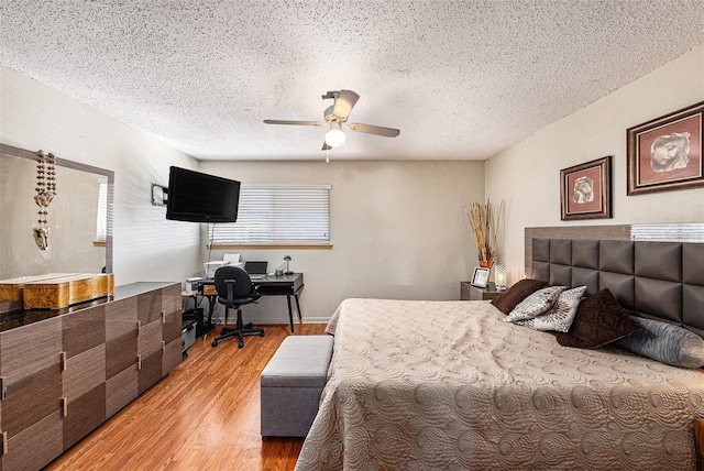 6308 Newtown Cir Unit 8C5, Tampa, FL 33615 - bedroom featuring baseboards, a textured ceiling, light wood-style flooring, and a ceiling fan