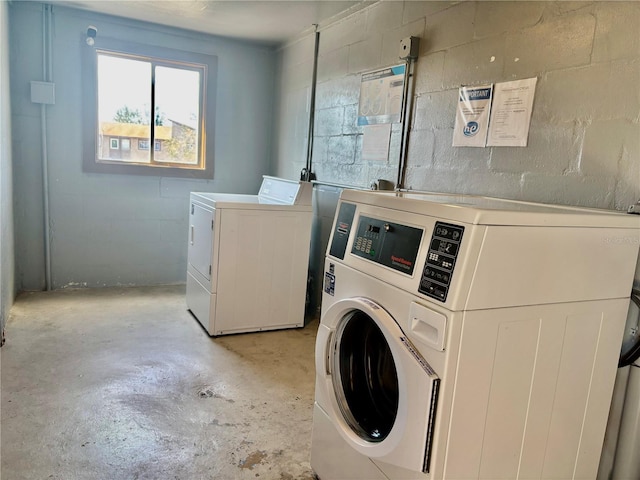6308 Newtown Cir Unit 8C5, Tampa, FL 33615 - common laundry area with concrete block wall and separate washer and dryer
